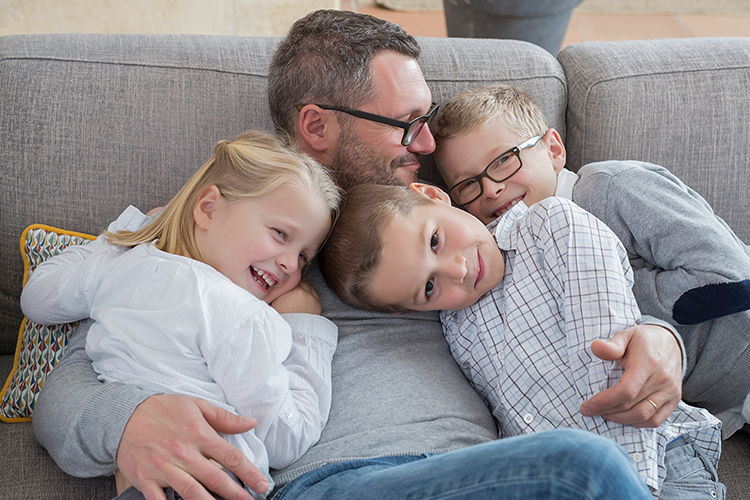 Man with his kids on couch